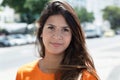 Smiling caucasian woman in a orange shirt in the city Royalty Free Stock Photo