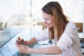 Smiling caucasian woman reading emails online on digital tablet computer Royalty Free Stock Photo