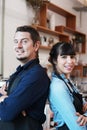 Smiling Caucasian Young barista couple love or partnership is wearing apron and happy for working in the coffee shop. Start up for Royalty Free Stock Photo