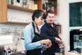 Smiling Caucasian Young barista couple love is wearing apron and cleaning a cup for working in the coffee shop. They are happy for Royalty Free Stock Photo