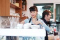 Smiling Caucasian Young barista couple love is wearing apron and working in the coffee shop. Start up for small cafe business Royalty Free Stock Photo