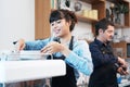 Smiling Caucasian Young barista couple love is wearing apron and working in the coffee shop. Start up for small cafe business Royalty Free Stock Photo