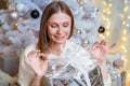 Smiling caucasian young woman opens box with christmas present. Christmas Royalty Free Stock Photo