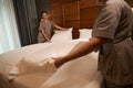 Team of maid service workers busy with changing bedclothes Royalty Free Stock Photo