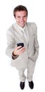 Smiling charismatic businessman sending a text Royalty Free Stock Photo