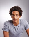 Smiling is charity. Studio shot of a young man posing against a gray background. Royalty Free Stock Photo