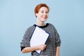 Smiling charming woman with short ginger holding clipboard with paper