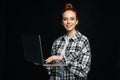 Smiling charming young business woman or student holding laptop computer and looking at camera Royalty Free Stock Photo