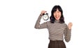 Smiling cheerful attractive young asian woman wearing sweater shirt holding alarm clock showing fist up looking camera isolated on Royalty Free Stock Photo