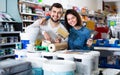 Couple purchasing tools for house improvements in paint supplies store Royalty Free Stock Photo