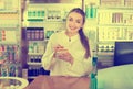 Smiling cheerful young female pharmacist posing Royalty Free Stock Photo