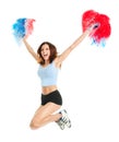 Smiling cheerleader girl posing with pom poms