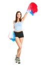 Smiling cheerleader girl posing with pom poms