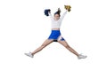 Smiling cheerleader girl raising pom poms on studio