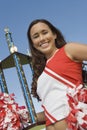 Smiling Cheerleader holding trophy Royalty Free Stock Photo