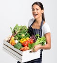 Smiling chef with apron holding fresh local organic produce Royalty Free Stock Photo