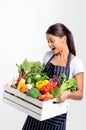 Smiling chef with apron holding fresh local organic produce Royalty Free Stock Photo