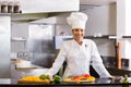 Smiling chef with cut vegetables in kitchen Royalty Free Stock Photo