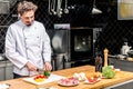 smiling chef cutting colored bell