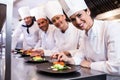 Smiling chef while decorating food plate Royalty Free Stock Photo