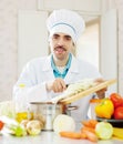 Smiling chef does veggy lunch Royalty Free Stock Photo