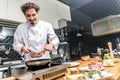 smiling chef frying meat