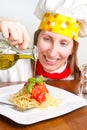 Smiling chef garnish an Italian pasta dish