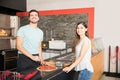 Smiling chef preparing customized pizza for customer