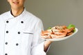 Smiling Chef proudly and happily presenting steamed crabs on the