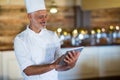 Smiling chef using digital tablet Royalty Free Stock Photo