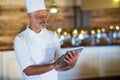Smiling chef using digital tablet Royalty Free Stock Photo