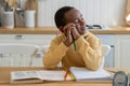 Smiling dreamy child African American boy procrastinating on doing homework Royalty Free Stock Photo