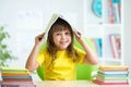 Smiling child with a book over her head Royalty Free Stock Photo