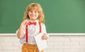 smiling child with book. teen boy in classroom. back to school. knowledge day. Royalty Free Stock Photo