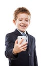 Smiling child boy in business suit holding mobile phone or smart Royalty Free Stock Photo