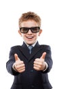 Smiling child boy in business suit wearing sunglasses gesturing Royalty Free Stock Photo