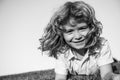 Smiling child boy enjoying on grass field and dreaming. Kids play on summer field. Royalty Free Stock Photo