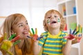 Smiling child boy and his mother having fun and showing hands painted in colorful paints Royalty Free Stock Photo