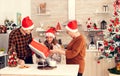 Smiling child during christmas celebration receiving gift box from cheerful senior man and woman. Royalty Free Stock Photo