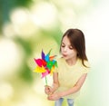 Smiling child with colorful windmill toy