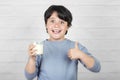 Smiling child drinking milk