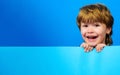 Smiling child with empty board. Little boy with blank sign for text. Advertising banner. Place for your advertisement Royalty Free Stock Photo