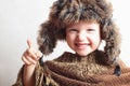 Smiling child in fur Hat.fashion winter style.little funny boy.children emotion Royalty Free Stock Photo