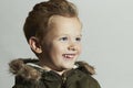 Smiling child.fur hood and winter jacket. fashion kids.children.happy little boy winter style Royalty Free Stock Photo