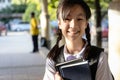 Smiling child girl with backpack on her back,holding a books on her arms going to school,cheerful schoolgirl wearing a school Royalty Free Stock Photo