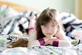 Smiling child girl in the bed in morning Royalty Free Stock Photo