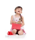 Smiling child girl holding gift box with kitten Royalty Free Stock Photo