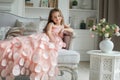 Smiling child girl in pink dress sitting on sofa at home Royalty Free Stock Photo