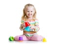 Smiling child girl playing with color toys Royalty Free Stock Photo