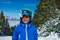 Smiling child in helmet and mask on alpine slopes Royalty Free Stock Photo